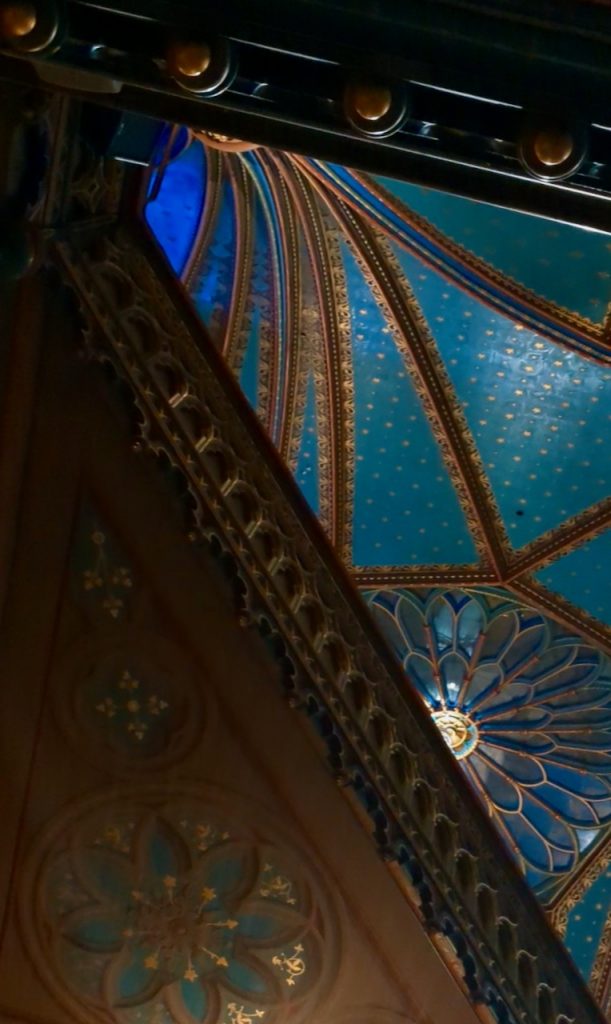 View of Notre-Dame Basilica of Montreal's ceiling with gold arching bands that are framed by wooden gallery edges